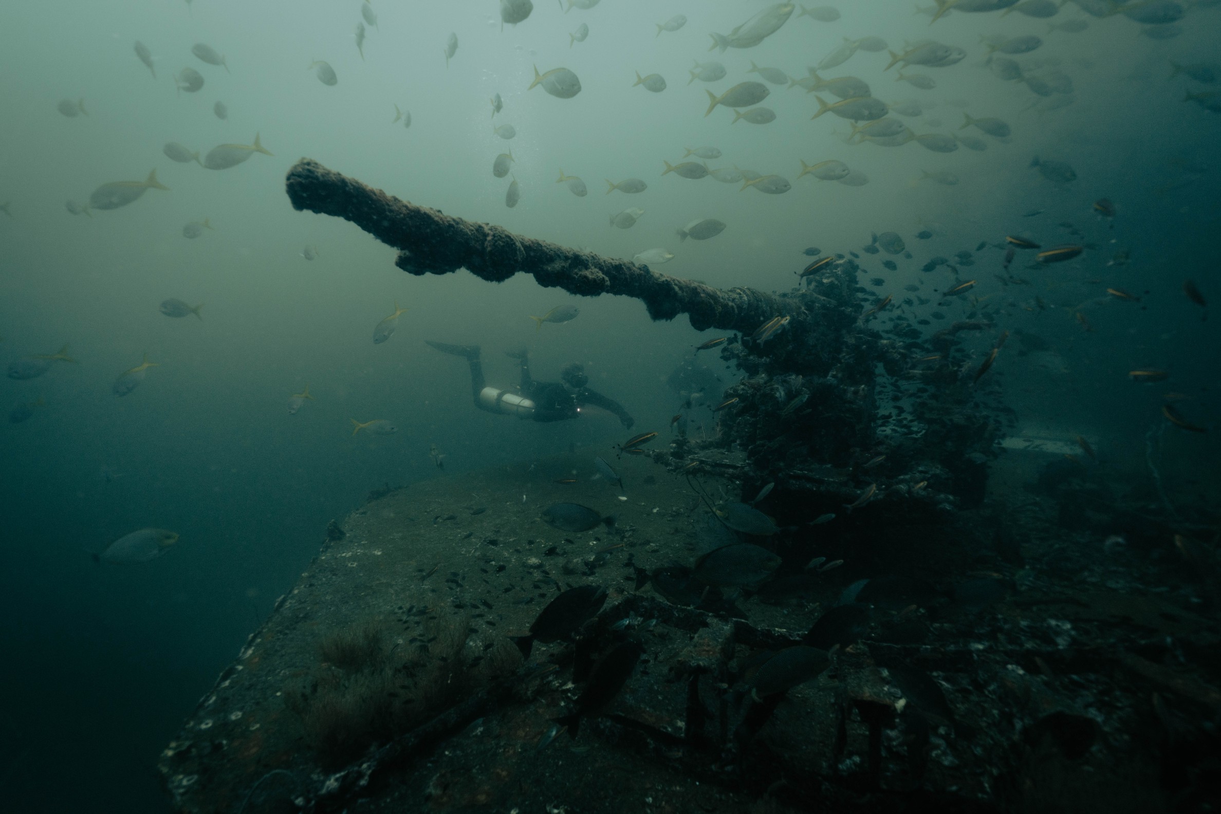 Sidemount scuba diver diving a shipwreck
